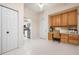 Hallway leading into the kitchen featuring a built-in desk and office space at 456 Pinewood Lake Dr, Venice, FL 34285