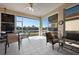 Enclosed lanai with ceiling fan, dining set and seating with a beautiful lake view at 456 Pinewood Lake Dr, Venice, FL 34285