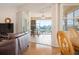 Comfortable living room with access to a screened-in patio offering a lovely lake view, perfect for relaxing at 456 Pinewood Lake Dr, Venice, FL 34285