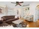 Spacious living room with hardwood floors, a built-in bookshelf, and cozy seating, offering a comfortable living space at 456 Pinewood Lake Dr, Venice, FL 34285