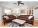 Bright living room featuring hardwood floors and comfortable seating, with an open view to the kitchen and dining area at 456 Pinewood Lake Dr, Venice, FL 34285