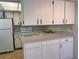 A bright kitchen with white cabinetry, countertops, and appliances at 460 Base E Ave # 129, Venice, FL 34285