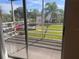 The screened patio provides a view of the well-manicured lawns and palm trees at 460 Base E Ave # 129, Venice, FL 34285