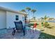 Cozy seating area in the backyard with a view of the scenic lake and swaying palm trees at 483 Circlewood Dr # O14, Venice, FL 34293
