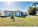 Backyard with well maintained lawn featuring a patio set perfect for outdoor dining and relaxation at 483 Circlewood Dr # O14, Venice, FL 34293