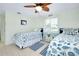 Bright bedroom featuring twin beds with nautical-themed bedding and a decorative ceiling fan at 483 Circlewood Dr # O14, Venice, FL 34293