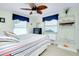 Inviting bedroom showcases a coastal-themed décor, light wood floors, and a stylish ceiling fan at 483 Circlewood Dr # O14, Venice, FL 34293