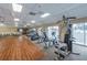 Bright exercise room featuring modern equipment and scenic water views through large windows at 483 Circlewood Dr # O14, Venice, FL 34293