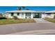 Charming home boasting turquoise accents, a convenient carport, and a beautifully maintained front yard at 483 Circlewood Dr # O14, Venice, FL 34293