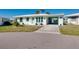 Attractive home with white exterior, turquoise accents, well-maintained lawn, and convenient carport at 483 Circlewood Dr # O14, Venice, FL 34293