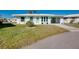 Charming single story home featuring a well maintained lawn with palm trees at 483 Circlewood Dr # O14, Venice, FL 34293