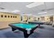 Spacious game room with pool tables, tables, and ample lighting for recreation and entertainment at 483 Circlewood Dr # O14, Venice, FL 34293