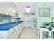 Bright kitchen features white cabinets, blue countertops, and a tile backsplash at 483 Circlewood Dr # O14, Venice, FL 34293