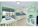 Bright kitchen featuring blue countertops, a lovely backsplash, and an adjacent dining area overlooking the lake at 483 Circlewood Dr # O14, Venice, FL 34293