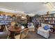 Cozy library filled with bookshelves and comfortable seating for reading and relaxation at 483 Circlewood Dr # O14, Venice, FL 34293