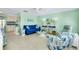 Spacious living area with bright interior, coastal decor, and plenty of natural light at 483 Circlewood Dr # O14, Venice, FL 34293