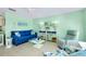 Bright living room featuring a blue sofa, coastal decor, and an airy, beach-inspired design at 483 Circlewood Dr # O14, Venice, FL 34293