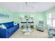 Comfortable living room with a blue sofa, beachy decorations, and a relaxing coastal vibe at 483 Circlewood Dr # O14, Venice, FL 34293