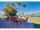 Picturesque patio with ample seating overlooking a tranquil lake surrounded by lush landscaping at 483 Circlewood Dr # O14, Venice, FL 34293