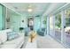 Relaxing sunroom with comfortable seating and sliding doors for seamless indoor-outdoor living at 483 Circlewood Dr # O14, Venice, FL 34293