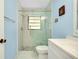 Modern bathroom featuring a glass-enclosed shower, mosaic tile, and stylish vanity at 49 Sandstone Cir, Venice, FL 34293