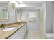 Bathroom featuring a double vanity with granite countertops, white cabinets, and modern fixtures at 49 Sandstone Cir, Venice, FL 34293