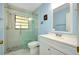 Modern bathroom featuring a glass-enclosed shower and a stylish vanity with a bright white countertop at 49 Sandstone Cir, Venice, FL 34293
