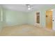 Neutral bedroom featuring carpet flooring and views into the en suite bathroom and walk-in closet at 49 Sandstone Cir, Venice, FL 34293