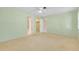 Neutral bedroom featuring carpet flooring and views into the walk-in closet and entry door at 49 Sandstone Cir, Venice, FL 34293