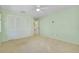 Spacious bedroom with carpet, closet, ceiling fan, and access to an ensuite bathroom at 49 Sandstone Cir, Venice, FL 34293