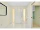 Bright foyer features white tile floors, front door with sidelights, and entry to living spaces at 49 Sandstone Cir, Venice, FL 34293