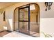 Inviting front entrance featuring a security gate with decorative wrought iron and tiled entryway at 49 Sandstone Cir, Venice, FL 34293