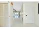 Bright hallway with white tile flooring leading to a spacious, open-concept living area at 49 Sandstone Cir, Venice, FL 34293