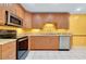 Well-lit kitchen with granite countertops and stainless steel appliances at 49 Sandstone Cir, Venice, FL 34293
