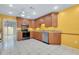 Well-lit kitchen with granite countertops and stainless steel appliances at 49 Sandstone Cir, Venice, FL 34293