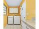 Laundry area features modern appliances, upper cabinets, and a functional countertop at 49 Sandstone Cir, Venice, FL 34293