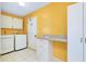 Functional laundry area with washer, dryer, utility sink, and storage cabinets at 49 Sandstone Cir, Venice, FL 34293
