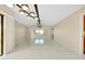 Bright, open living room with white tile flooring and contemporary lighting fixtures at 49 Sandstone Cir, Venice, FL 34293