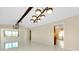 Open-concept living room with white tile, modern lighting, and views into adjacent rooms at 49 Sandstone Cir, Venice, FL 34293