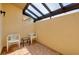 Covered patio area with brick flooring, outdoor seating and a light-filled overhead structure at 49 Sandstone Cir, Venice, FL 34293