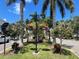 Manicured green space along street with trees, flowers, and ornate street lighting at 49 Sandstone Cir, Venice, FL 34293