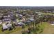 An aerial view showcases charming homes and golf course views in a tranquil and well-maintained neighborhood at 5017 Canterbury Dr, Sarasota, FL 34243