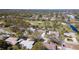 Wide aerial shot shows the neighborhood, a nearby golf course, and the home with a large pool at 5017 Canterbury Dr, Sarasota, FL 34243