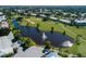 Stunning aerial view of golf course, community pond with fountain, and lush landscaping offering serene community views at 503 Clubside Cir # 47, Venice, FL 34293