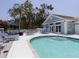 Inviting community pool area with lounge chairs, tables, and a clubhouse for relaxation and socializing at 503 Clubside Cir # 47, Venice, FL 34293