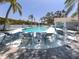 Relaxing pool area with lounge chairs, tables, and umbrellas for enjoying the sun and water at 503 Clubside Cir # 47, Venice, FL 34293
