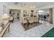 Bright dining room boasts white tile floors, stylish furniture, and access to outdoor patio space at 503 Clubside Cir # 47, Venice, FL 34293
