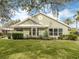 Exterior view of the home with a well-manicured lawn and lush landscaping at 503 Clubside Cir # 47, Venice, FL 34293