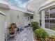 Welcoming front porch with brick pavers, a cozy seating area, and a view of the front door at 503 Clubside Cir # 47, Venice, FL 34293