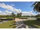 Scenic view of the landscaped golf course, showcasing a serene pond and inviting brick pathway enhancing outdoor enjoyment at 503 Clubside Cir # 47, Venice, FL 34293